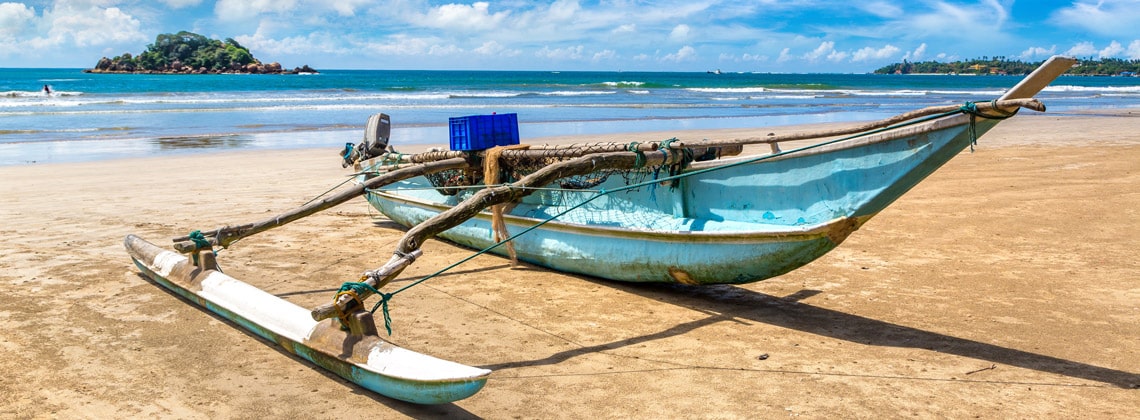Pirogue bleue sur la plage - Voyage solidaire Sri Lanka